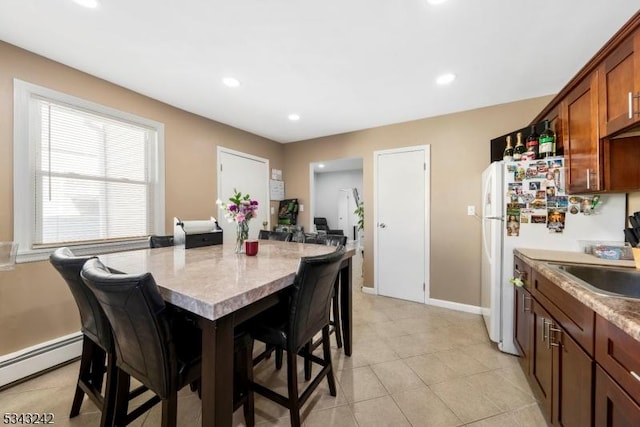 dining area featuring recessed lighting, a baseboard heating unit, baseboards, and light tile patterned floors