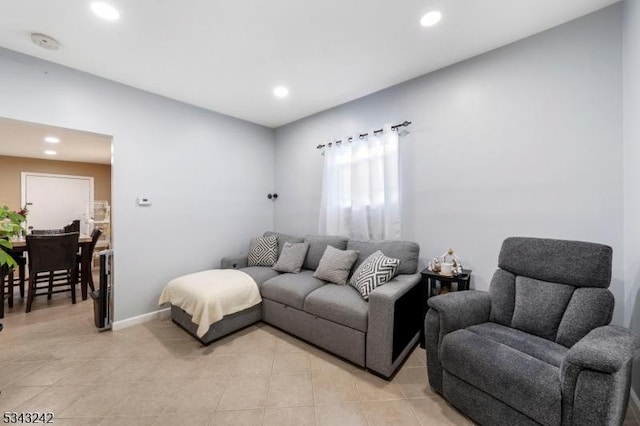 living room featuring light tile patterned flooring, recessed lighting, and baseboards