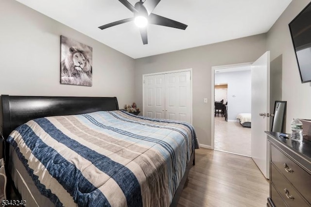 bedroom with ceiling fan, a closet, baseboards, and light wood-style flooring