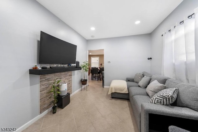 living room featuring light tile patterned floors, recessed lighting, and baseboards