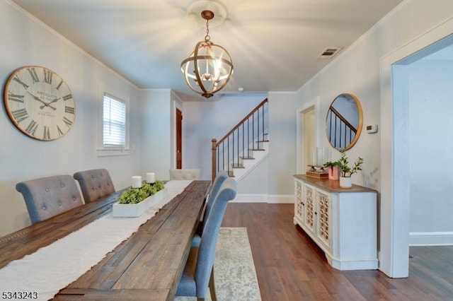 dining space with visible vents, ornamental molding, dark wood finished floors, an inviting chandelier, and stairs