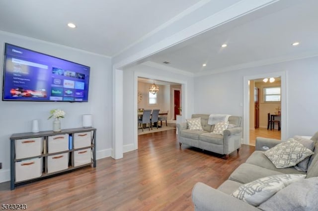 living area with recessed lighting, wood finished floors, baseboards, and ornamental molding