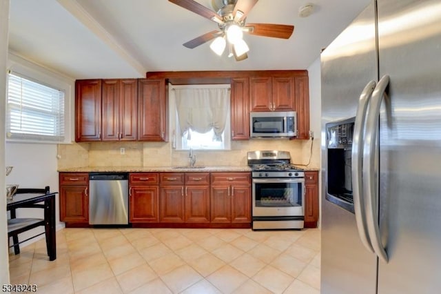 kitchen featuring a sink, decorative backsplash, a healthy amount of sunlight, and stainless steel appliances