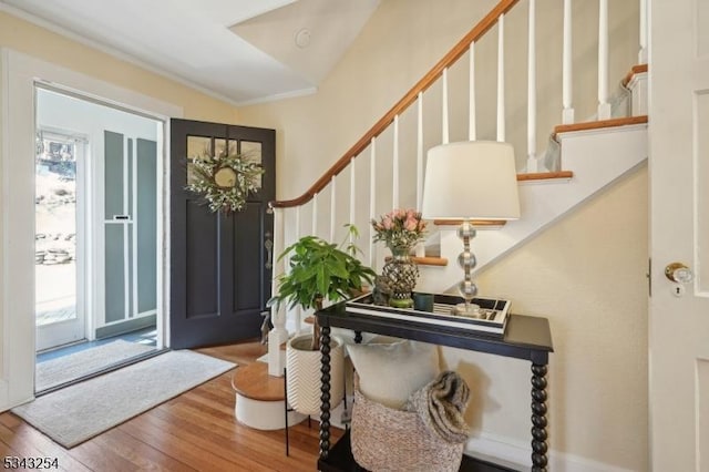 foyer entrance with stairway and wood-type flooring