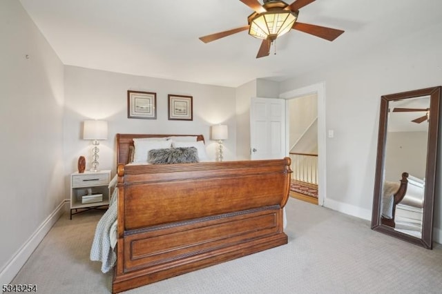 bedroom with ceiling fan, baseboards, and light carpet