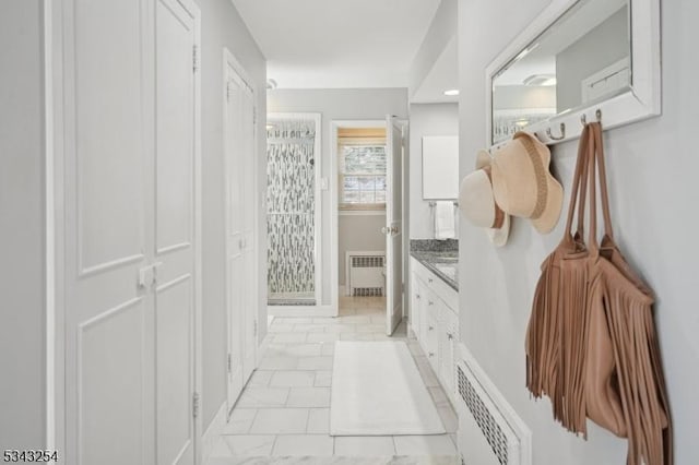 mudroom with visible vents, radiator, and marble finish floor