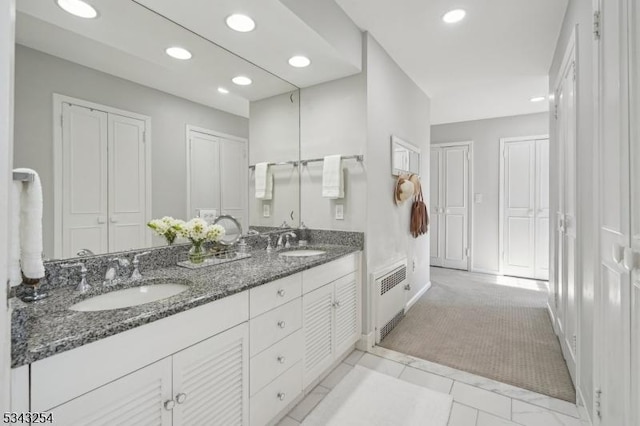 full bathroom featuring double vanity, recessed lighting, visible vents, and a sink