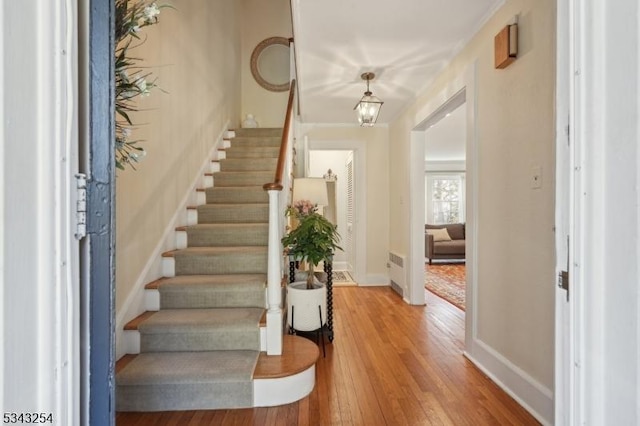 entryway featuring stairway, baseboards, and light wood finished floors