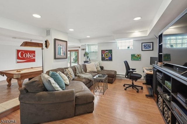 living room with a wealth of natural light, visible vents, light wood-style floors, and recessed lighting