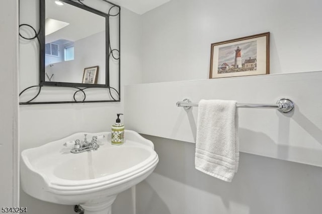 bathroom with visible vents and a sink