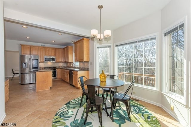 dining room featuring a wealth of natural light, a notable chandelier, recessed lighting, and baseboards