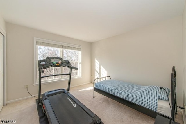 carpeted bedroom featuring baseboards