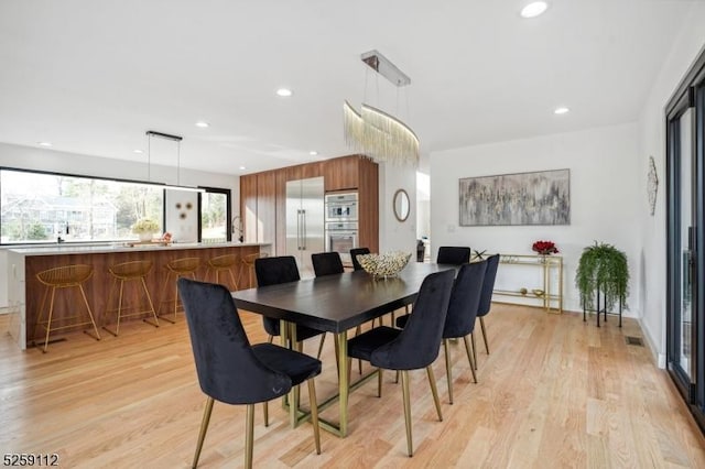 dining area featuring recessed lighting, visible vents, and light wood finished floors