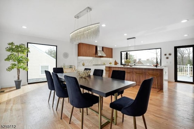 dining room with recessed lighting and light wood finished floors