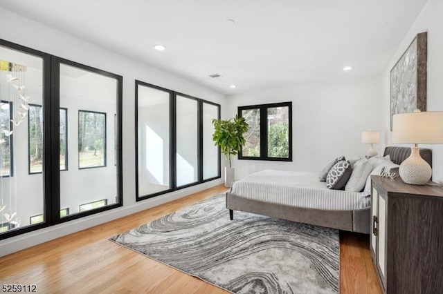 bedroom featuring recessed lighting, wood finished floors, and visible vents