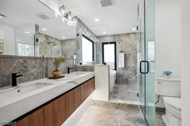 full bathroom featuring visible vents, a stall shower, toilet, and a sink