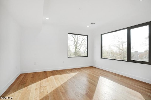 spare room with recessed lighting, visible vents, baseboards, and light wood-style floors