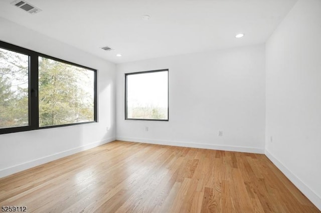 spare room featuring recessed lighting, visible vents, baseboards, and light wood-style flooring