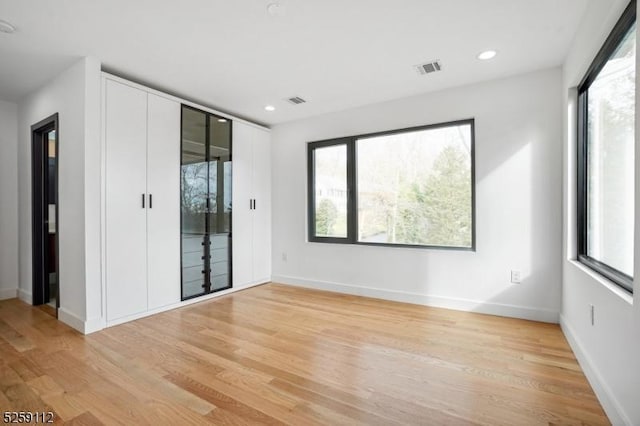 unfurnished bedroom with access to outside, recessed lighting, baseboards, and light wood-type flooring