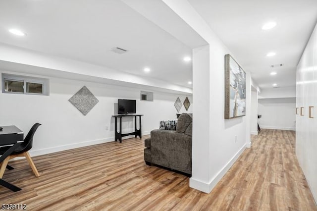 hallway with visible vents, recessed lighting, light wood-type flooring, and baseboards