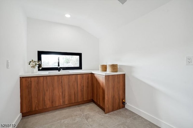 bar featuring vaulted ceiling, recessed lighting, baseboards, and a sink