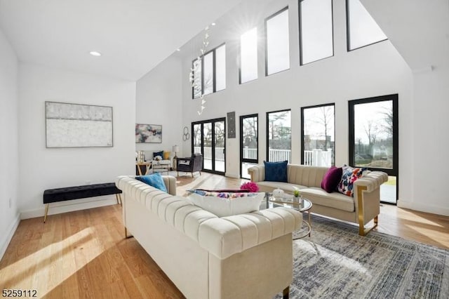 living room featuring recessed lighting, wood finished floors, and baseboards