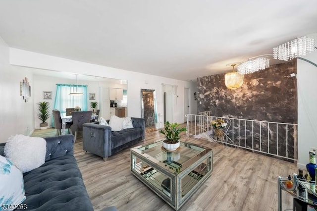 living area featuring a notable chandelier and light wood finished floors