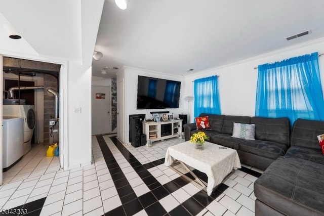 living room with tile patterned floors, separate washer and dryer, and visible vents