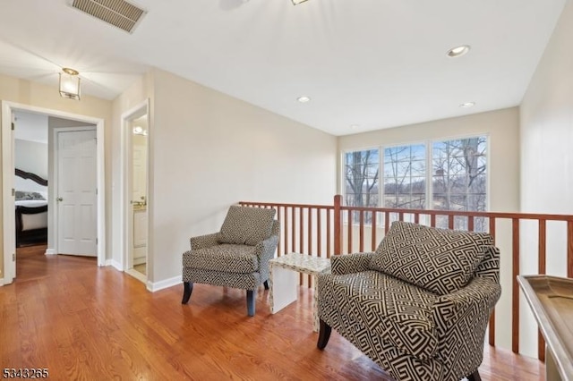 sitting room featuring visible vents, recessed lighting, baseboards, and wood finished floors