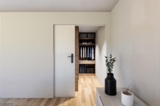 corridor with light wood-style floors