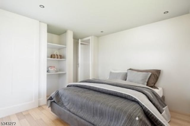 bedroom with light wood-style floors