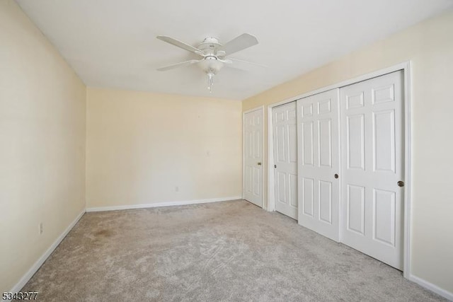 unfurnished bedroom with a ceiling fan, carpet, baseboards, and a closet