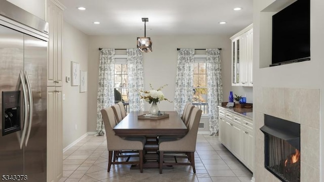 dining room with a wealth of natural light, light tile patterned floors, and recessed lighting