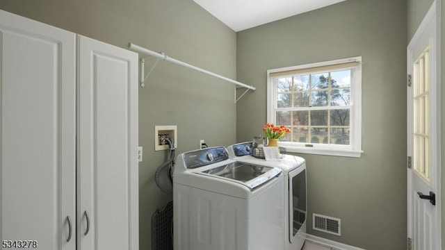 laundry room with laundry area, washing machine and dryer, baseboards, and visible vents