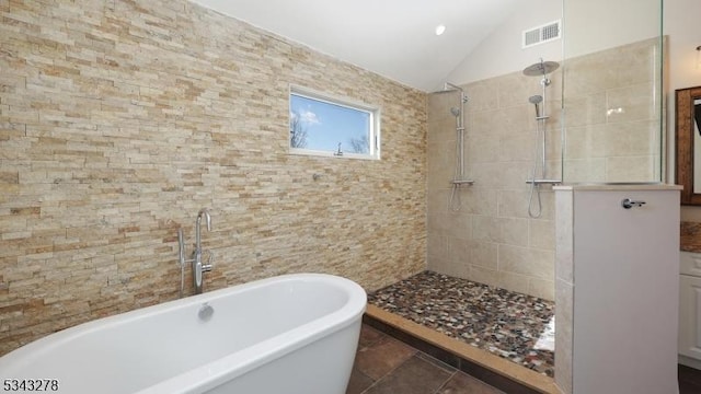 bathroom with visible vents, a walk in shower, tile patterned flooring, lofted ceiling, and a soaking tub