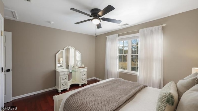 bedroom with visible vents, a ceiling fan, dark wood-type flooring, and baseboards