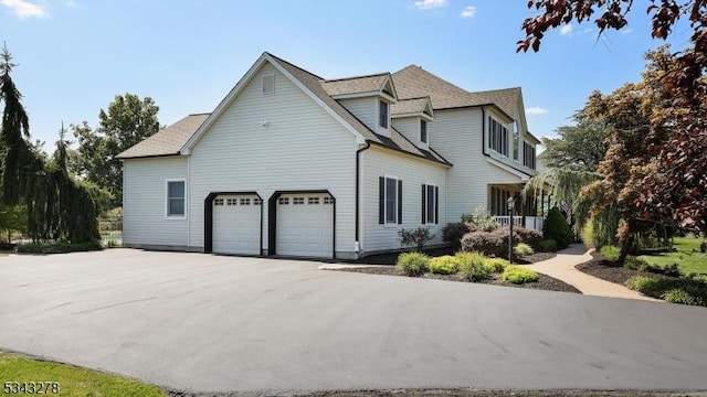 view of home's exterior featuring a garage and driveway