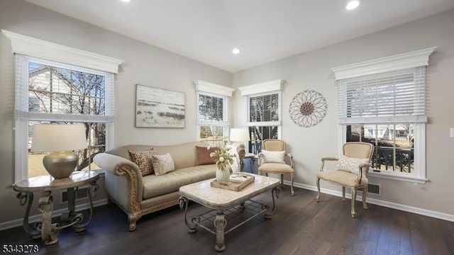 living area featuring recessed lighting, a healthy amount of sunlight, baseboards, and wood finished floors