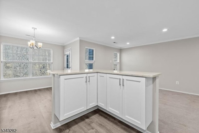 kitchen featuring white cabinetry, light countertops, baseboards, and ornamental molding