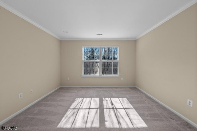 carpeted empty room with crown molding and baseboards