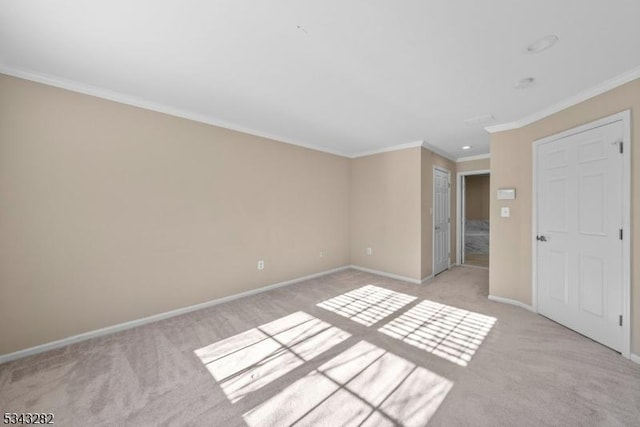 unfurnished bedroom with baseboards, light carpet, and ornamental molding