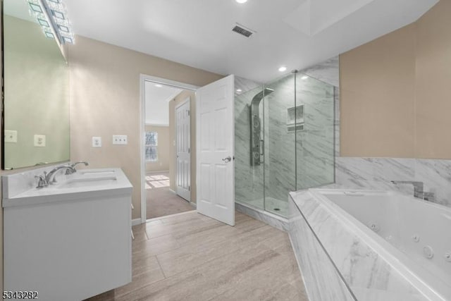 full bathroom featuring a marble finish shower, visible vents, double vanity, a whirlpool tub, and a sink