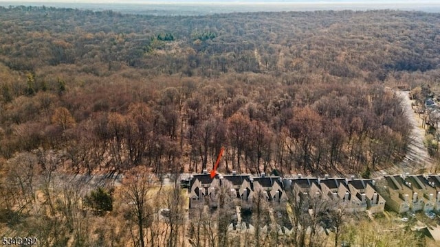 birds eye view of property featuring a wooded view