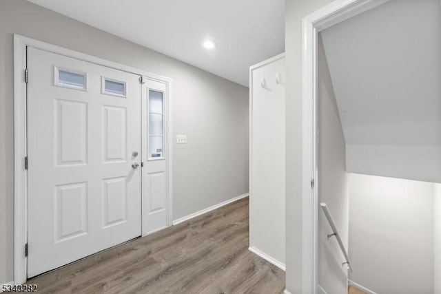 foyer with baseboards and wood finished floors