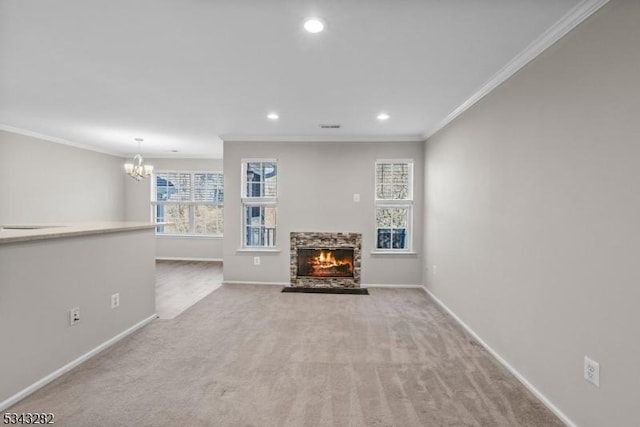 unfurnished living room featuring a stone fireplace, crown molding, and baseboards