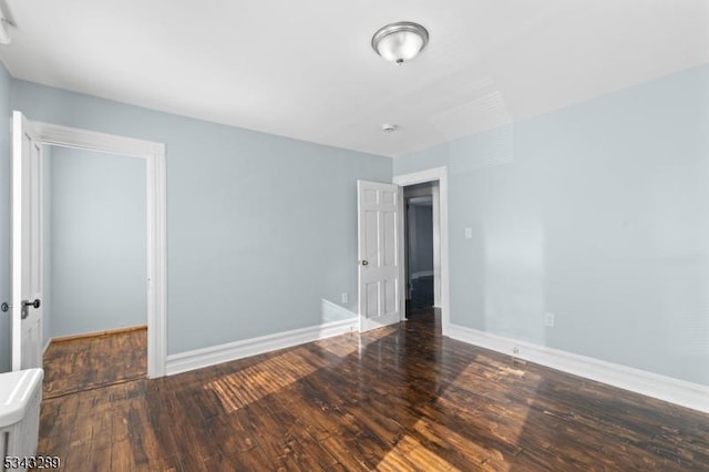 unfurnished bedroom with baseboards and wood finished floors