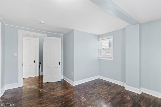 empty room with baseboards and wood finished floors