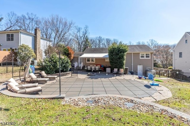 rear view of house featuring a patio and fence