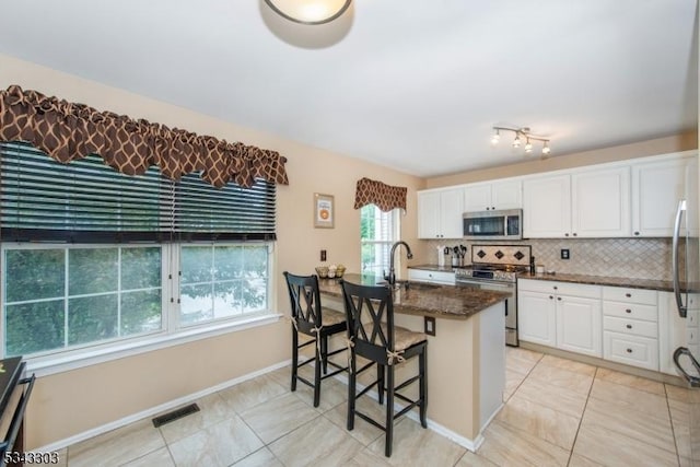 3 Knox Ct, Bernards Twp, NJ 07920 - kitchen featuring appliances with stainless steel finishes, white cabinets, dark stone countertops, and tasteful backsplash