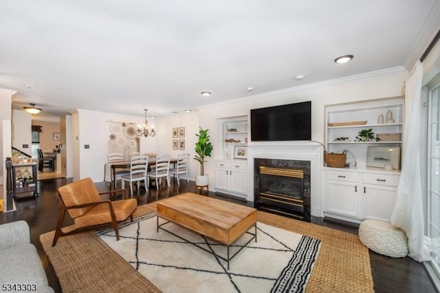 3 Knox Ct, Bernards Twp, NJ 07920 - living area with wood finished floors, ornamental molding, a chandelier, a premium fireplace, and built in features